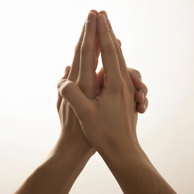Hands clasped in prayer, symbolizing spiritual reflection and connection
